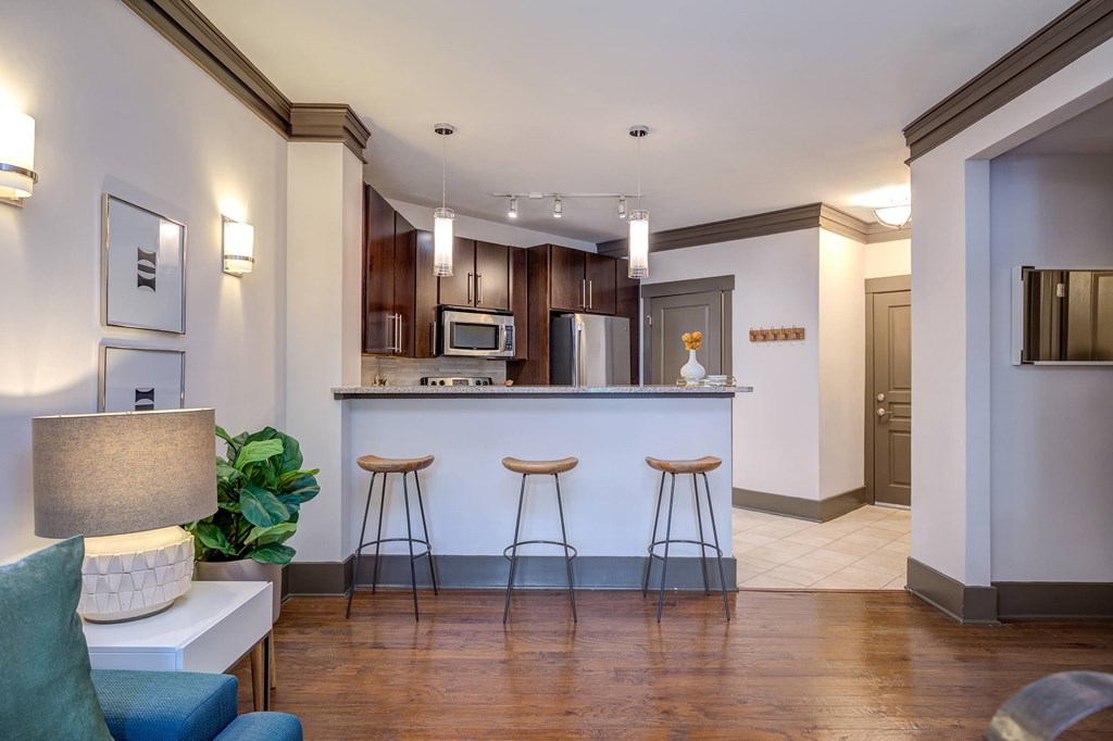 A kitchen with a bar area and a couch.