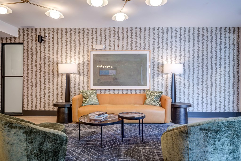 A room with a patterned wallpaper and a large painting on the wall.