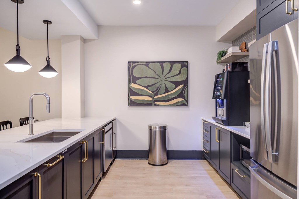 A modern kitchen with a large painting on the wall.