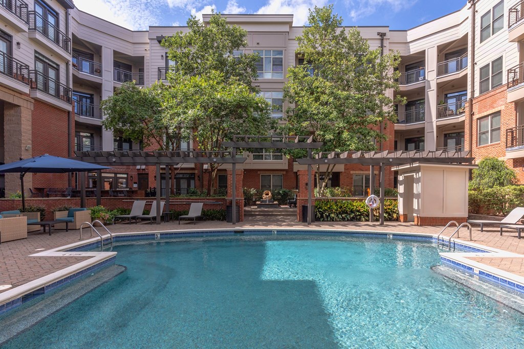 A swimming pool in front of apartment buildings.