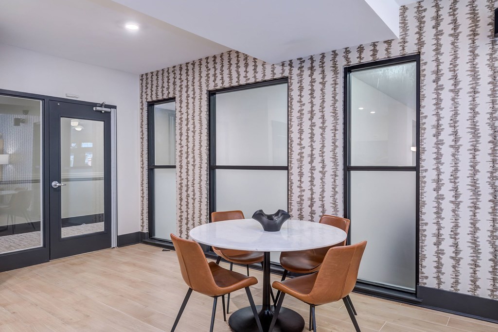 A room with a round table and chairs.