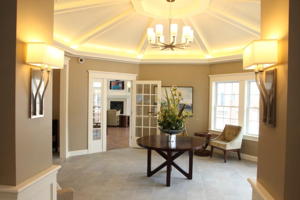 a living room with a table and a chandelier