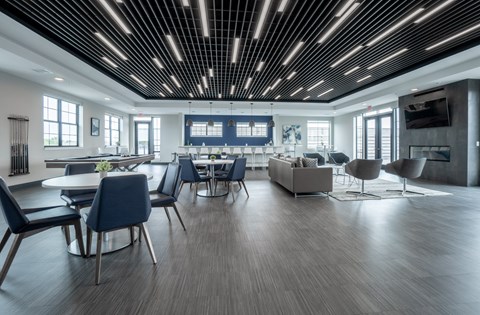 A modern dining room with a long table and chairs.