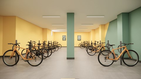 A room with a row of bicycles parked on the floor.