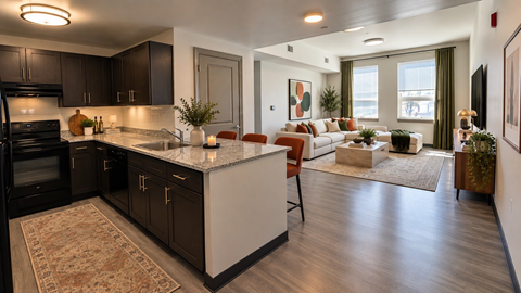 A modern kitchen with dark brown cabinets and a white island.