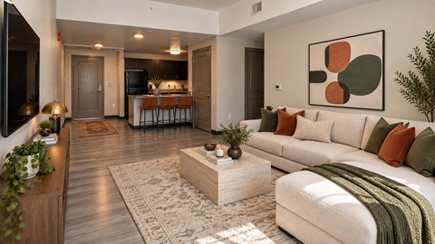 A modern living room with a white sofa and a large abstract painting on the wall.