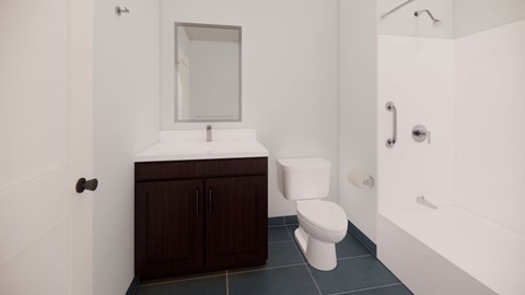 A white toilet sits in a bathroom with a white sink and a mirror.