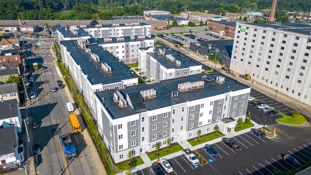 an aerial view of an apartment building with a black roof