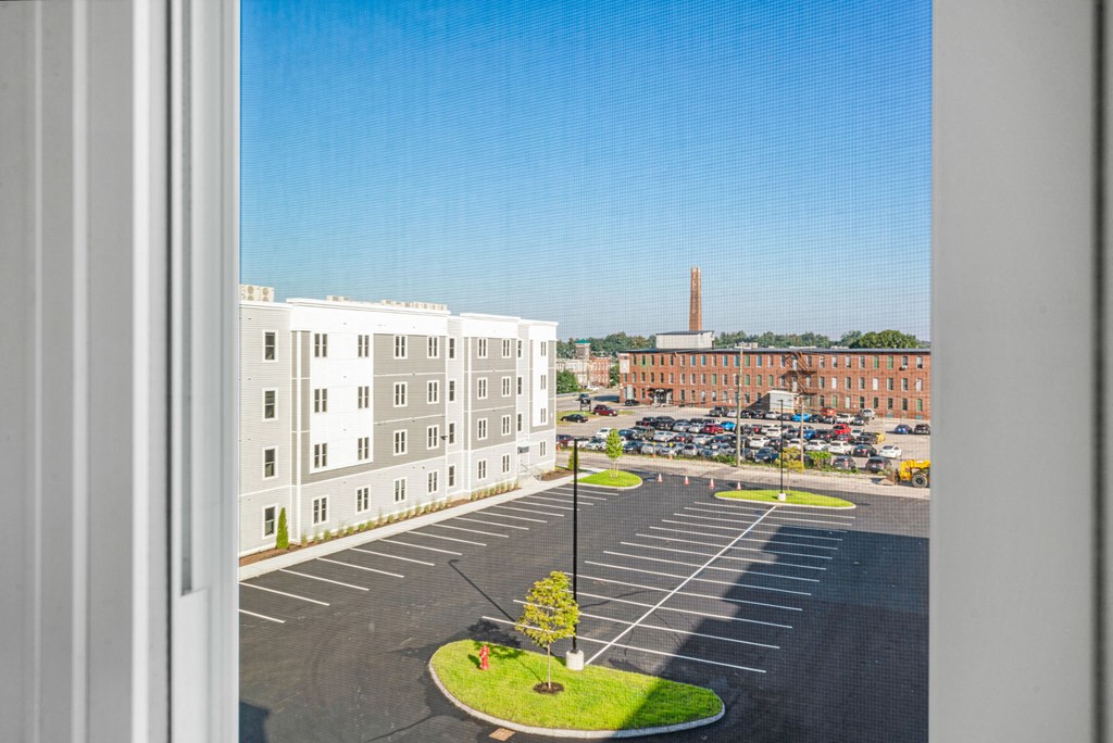 a view of a parking lot from a window of a building