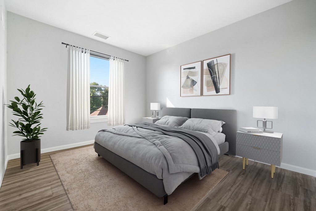 an empty bedroom with a bed and a window