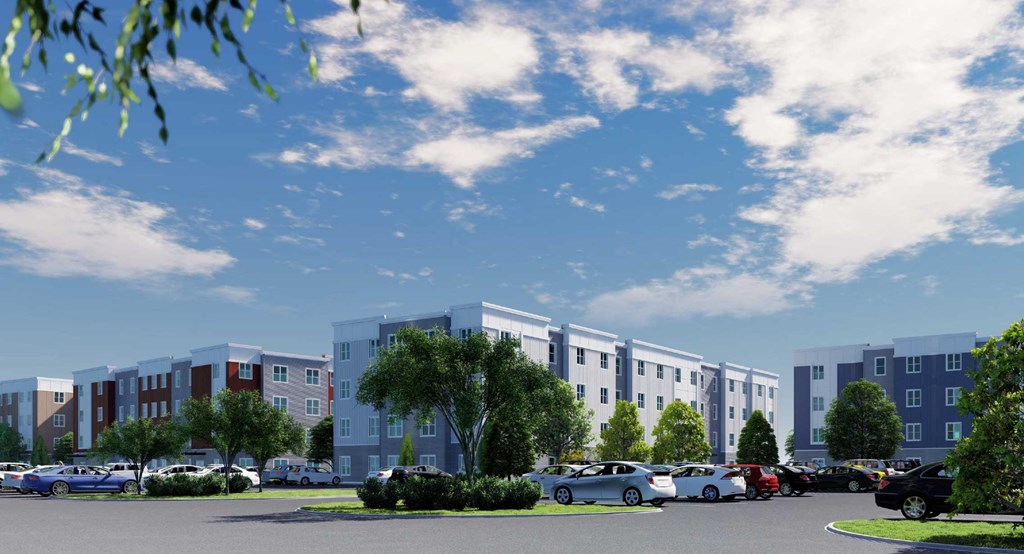 Parking area with trees and buildings beyond