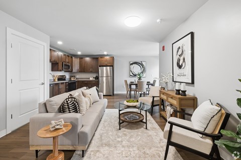 A living room with a grey couch and a wooden coffee table.