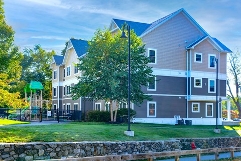 A large house with a playground in front.