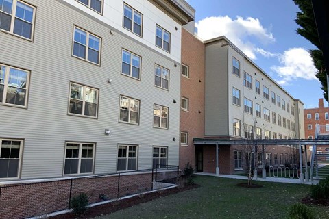 A building with a mix of grey and red brick exterior.