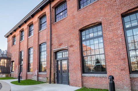 Black doors and trim, oversized windows, beautiful brickwork.