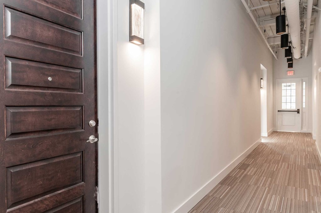 Hallway with high ceilings and exposed loft features