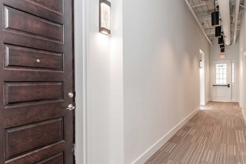 Hallway with high ceilings and exposed loft features