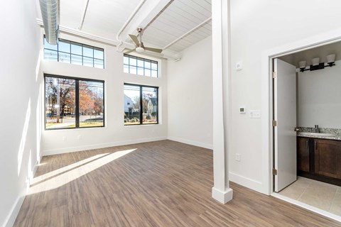 Modern plank flooring, oversized windows, high ceilings with exposed loft features