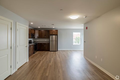 A kitchen with wooden floors and white walls.