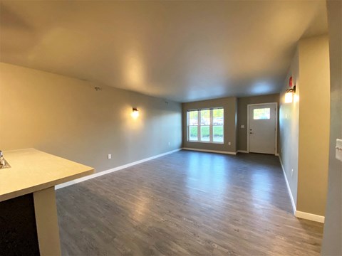 the living room and dining room of a new home