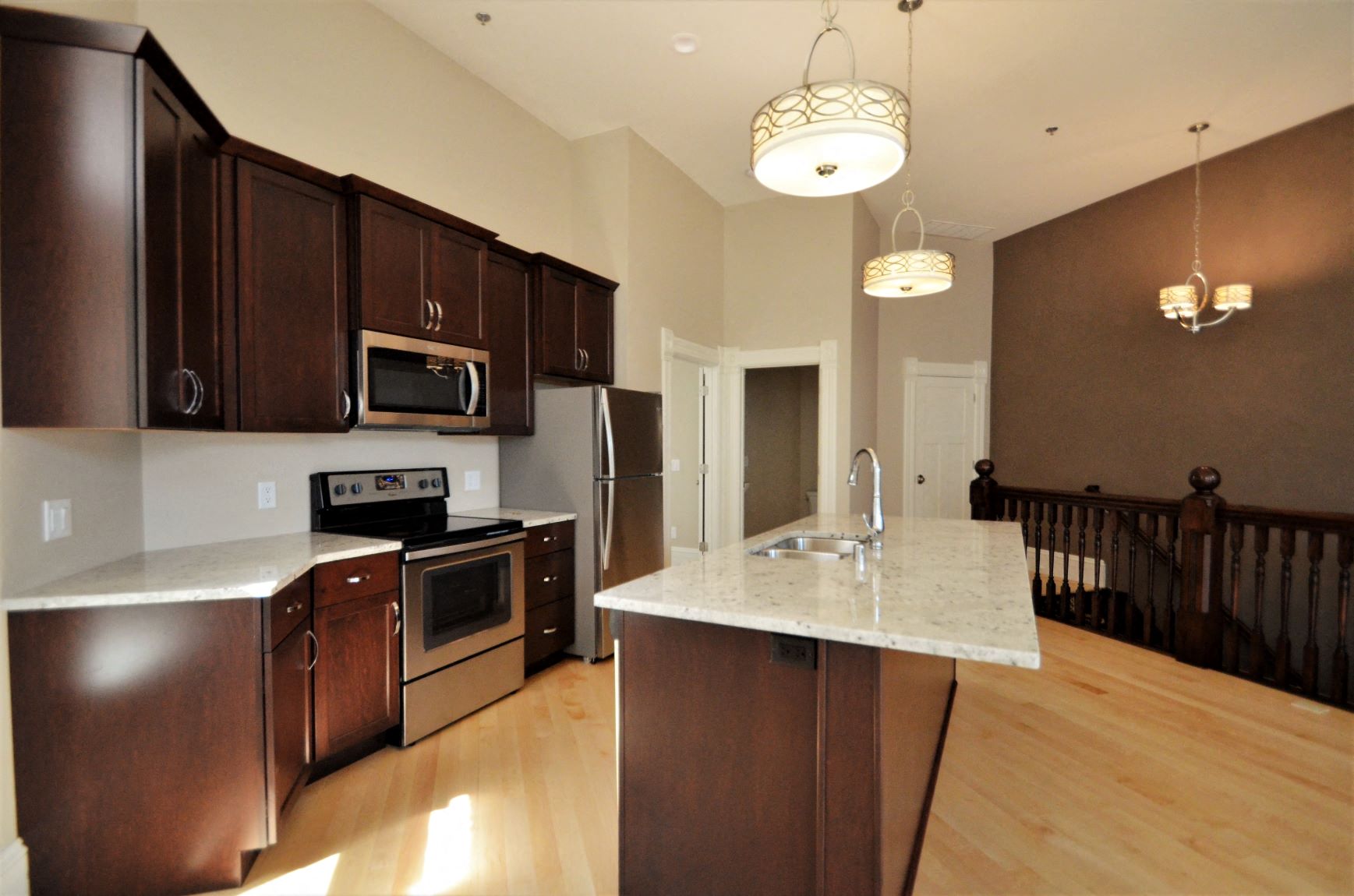 a kitchen with stainless steel appliances and a marble counter top
