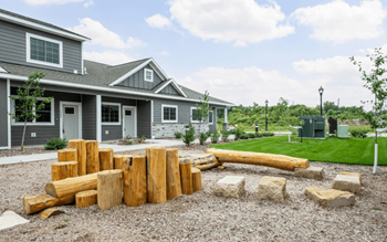 a view of a backyard with a fire pit and a house