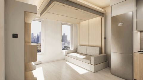 A modern living room with a large window and a couch.