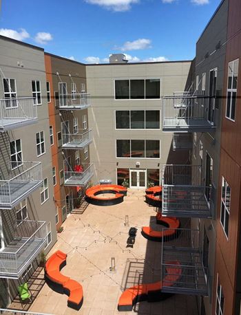 an aerial view of an apartment complex with orange benches