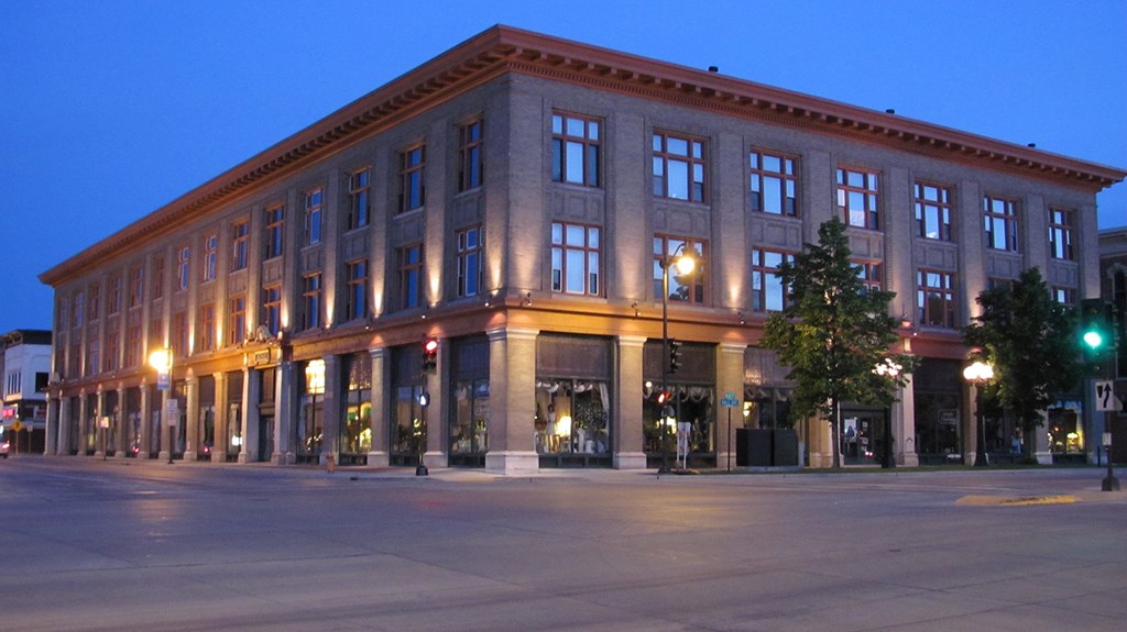 a building on the corner of a city street at night