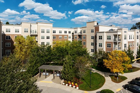 A large apartment complex with a courtyard and trees.