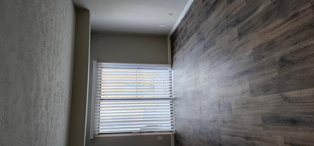 a hallway with a window and a wooden wall