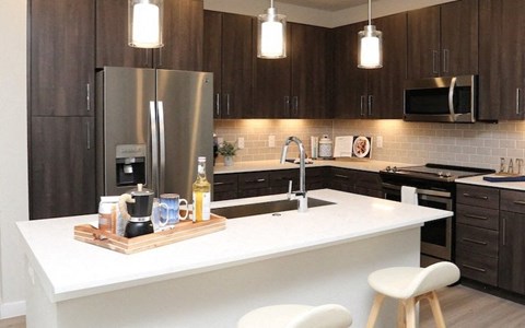 a kitchen with a counter top and a refrigerator