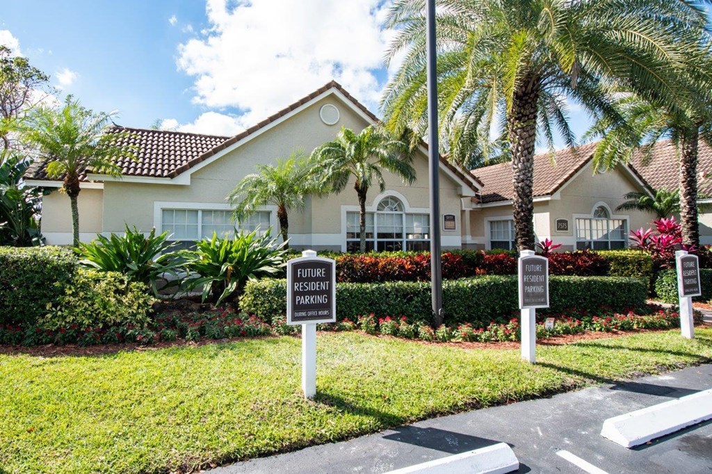 a house with palm trees and signs in front of it