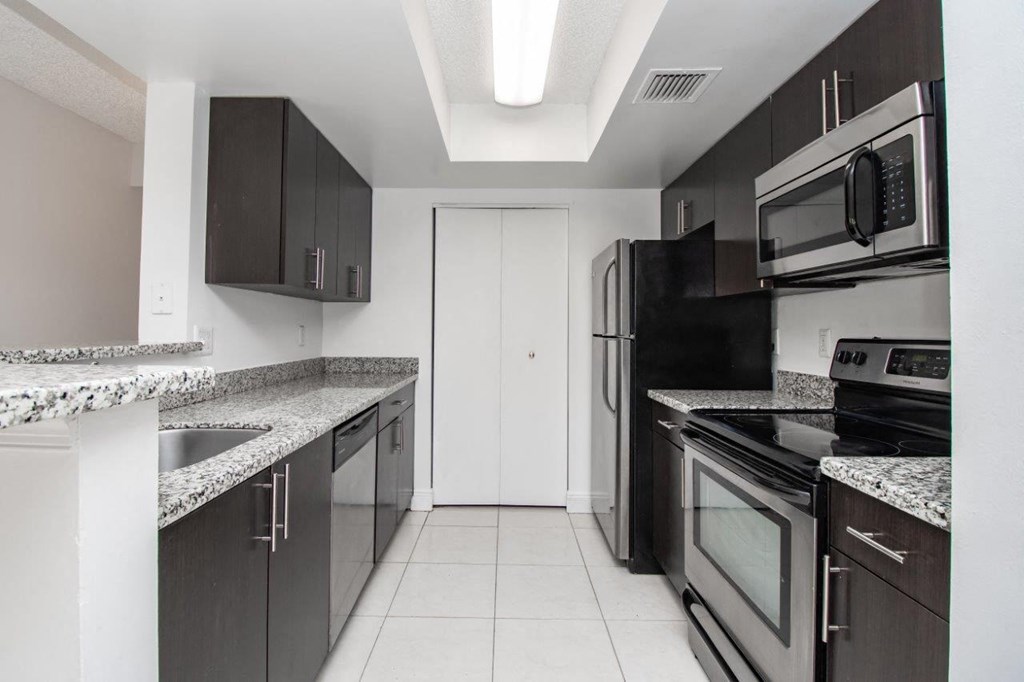 a kitchen with stainless steel appliances and granite counter tops