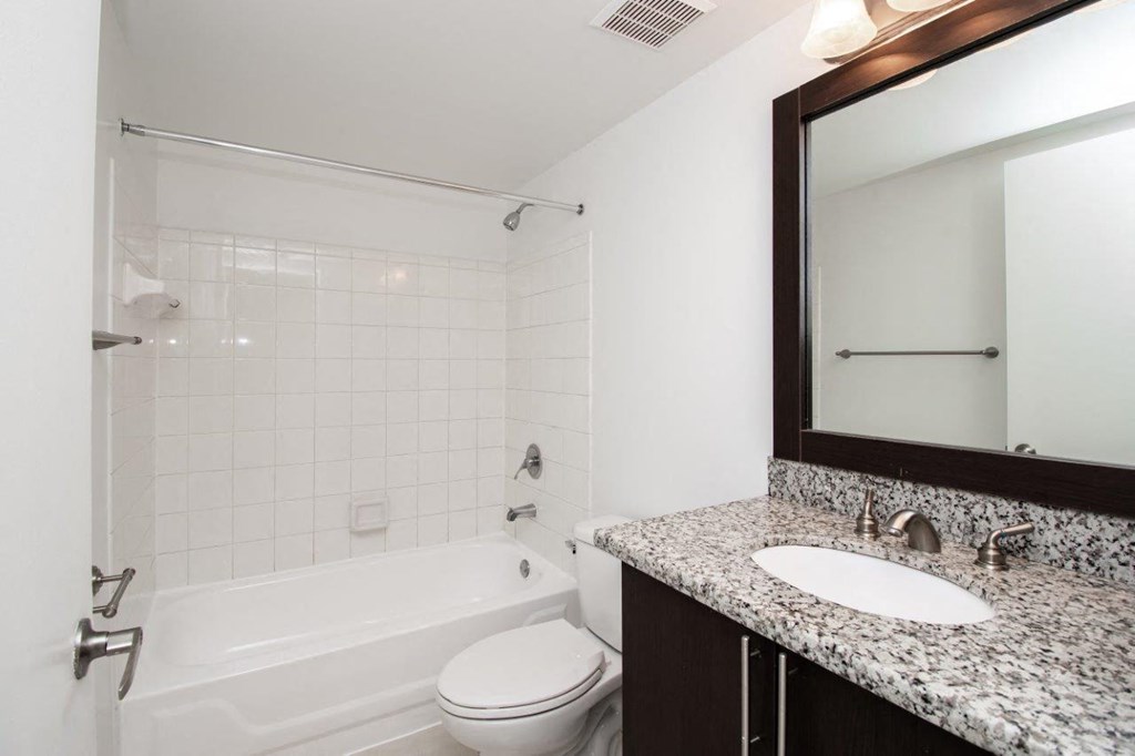 a bathroom with a sink toilet and a bath tub