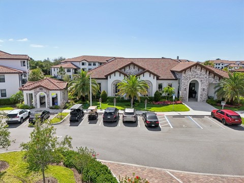 A parking lot with cars and a building in the background.