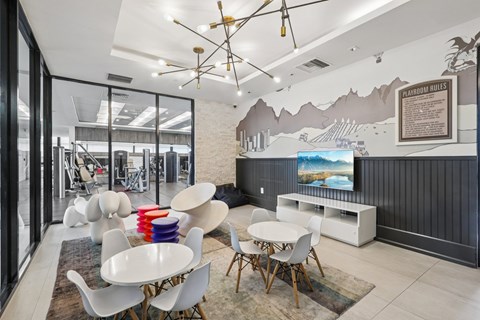 A modern dining room with a large table and chairs.