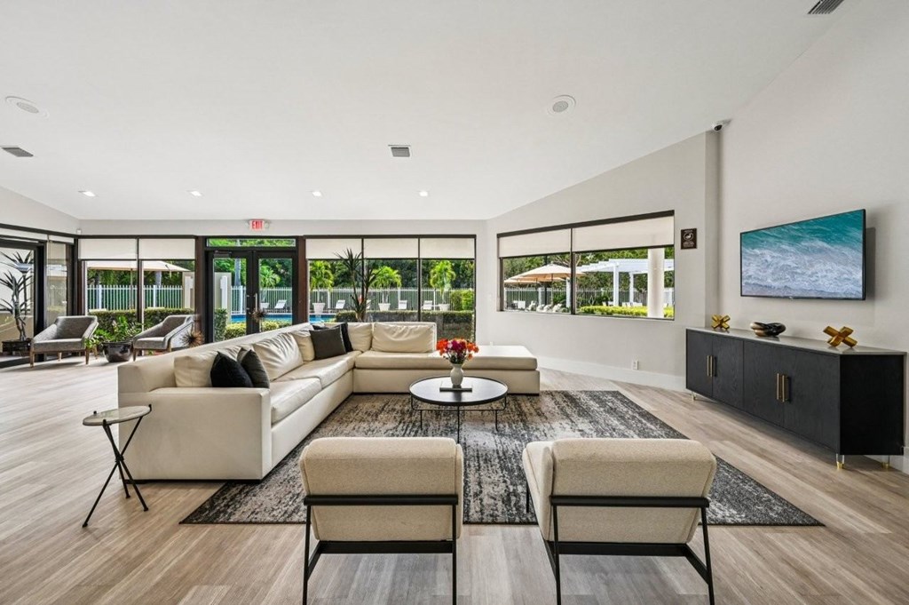 A modern living room with a large window and a view of the ocean.