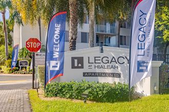 a sign for legacy apartments in front of a building