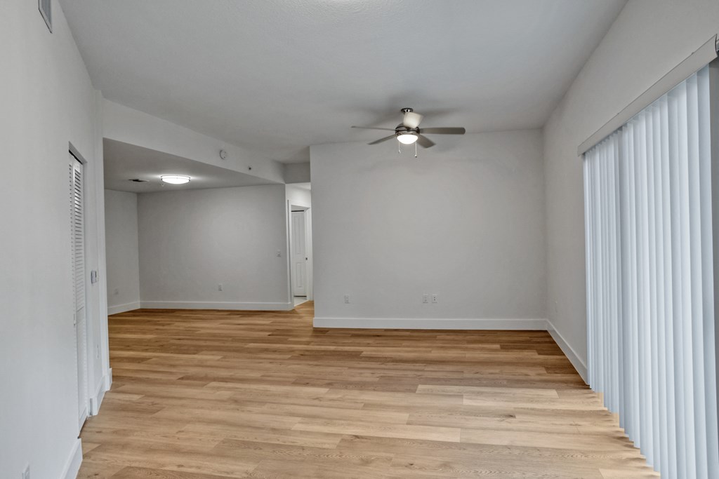 a bedroom with a ceiling fan and hardwood floors