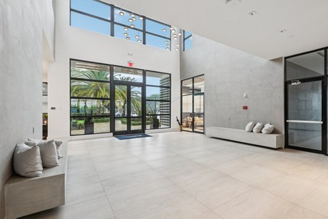 A modern interior with a glass door leading to a balcony.