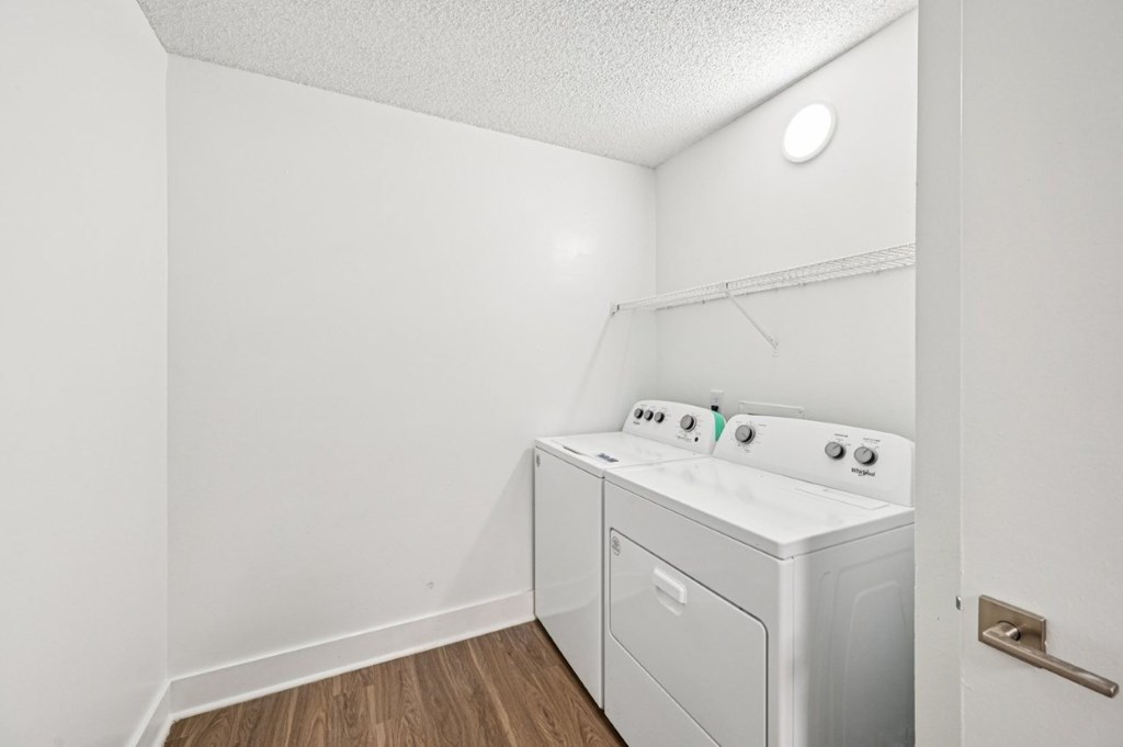 A white washer and dryer in a small laundry room.