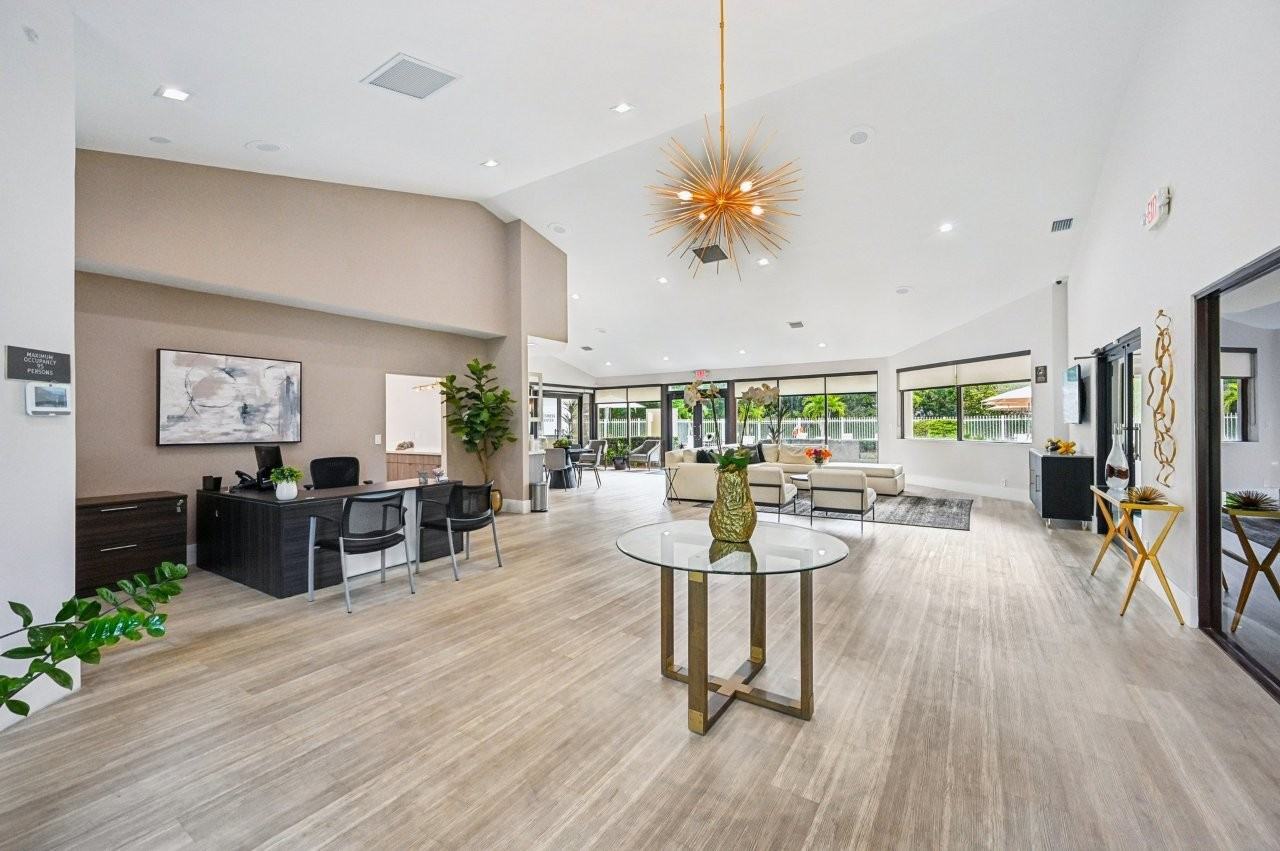 A modern living room with a glass table and chairs.