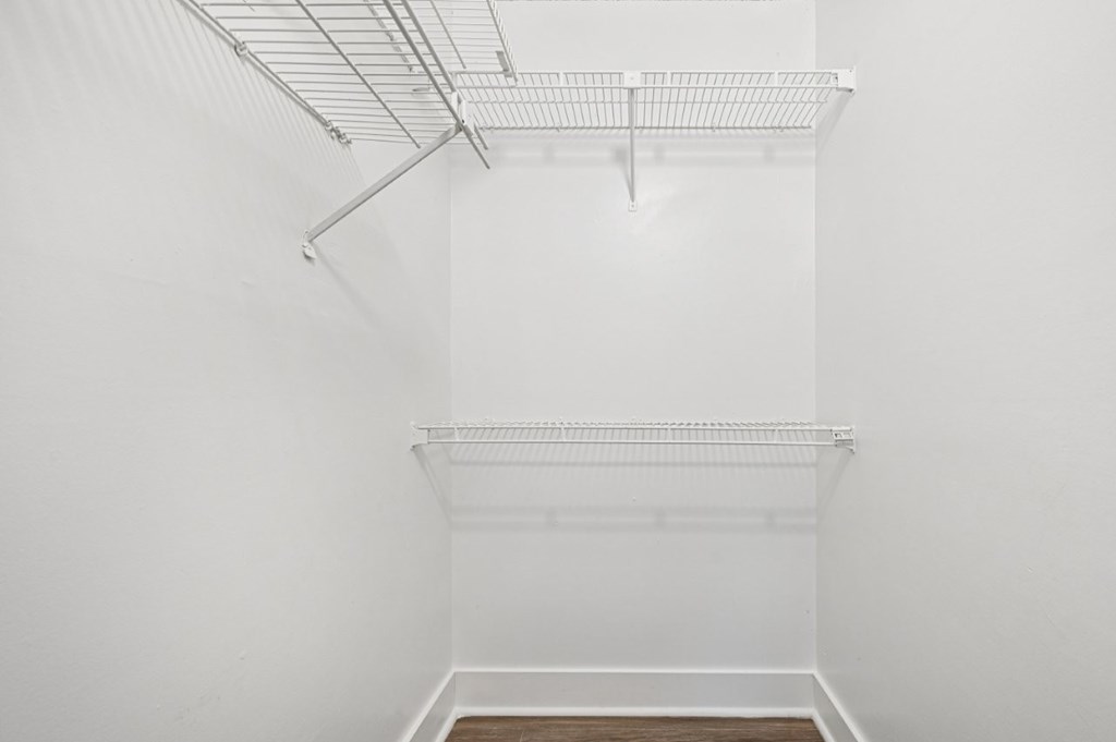 Empty white room with a shelf and a white floor.