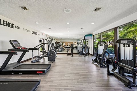 A gym with treadmills, weights and exercise machines.