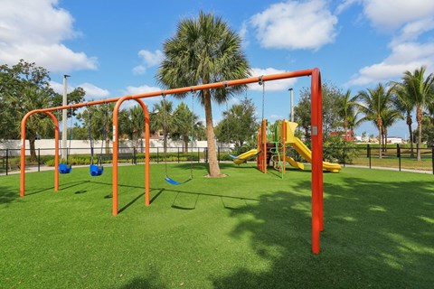 A playground with a swing set and a slide.