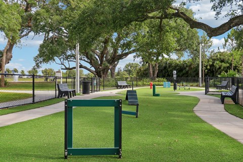 A green square frame stands on a green lawn in a park.