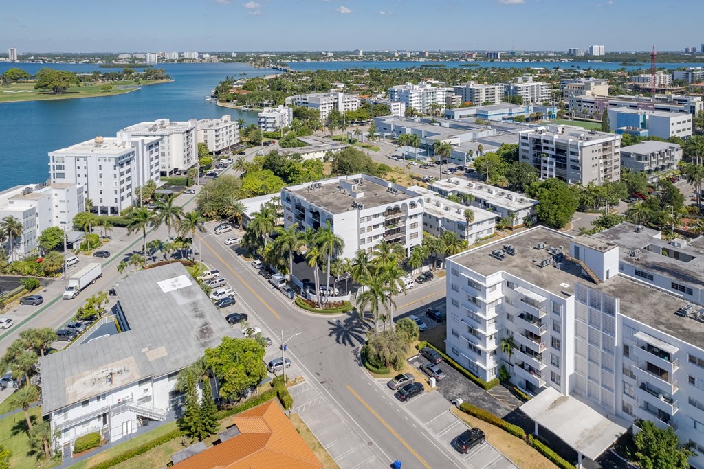 an aerial view of a city with buildings and a body of water