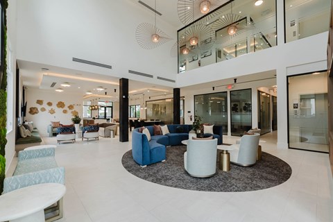 A modern living room with a white ceiling and a glass wall.