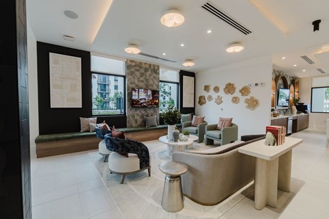 A modern office lobby with a reception desk and comfortable seating areas.